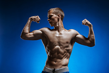 Image showing Fit young man with beautiful torso on blue background