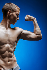 Image showing Fit young man with beautiful torso on blue background