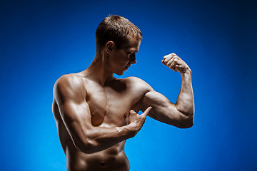 Image showing Fit young man with beautiful torso on blue background