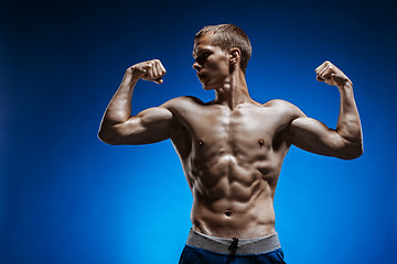 Image showing Fit young man with beautiful torso on blue background