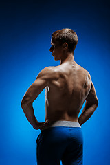 Image showing Fit young man with beautiful torso on blue background