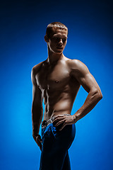 Image showing Fit young man with beautiful torso on blue background