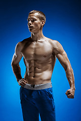 Image showing Fit young man with beautiful torso on blue background