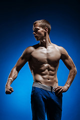 Image showing Fit young man with beautiful torso on blue background