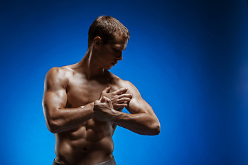 Image showing Fit young man with beautiful torso on blue background