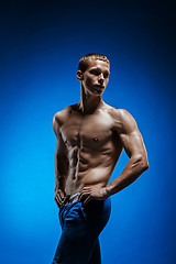 Image showing Fit young man with beautiful torso on blue background