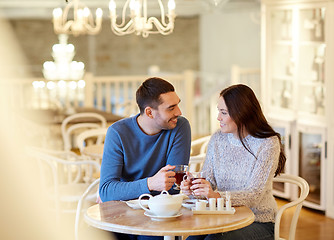 Image showing happy couple drinking tea at cafe