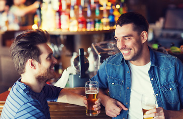 Image showing happy male friends drinking beer at bar or pub