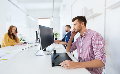 Image showing man or designer with computer and tablet at office