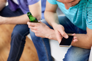 Image showing close up of man with smartphone and beer at home