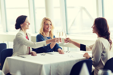 Image showing happy women drinking champagne at restaurant