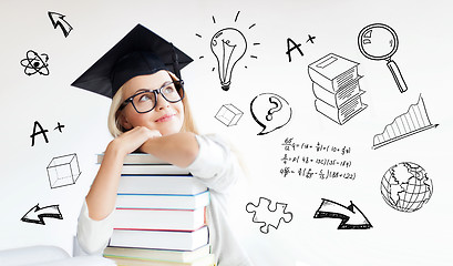 Image showing happy student woman in mortarboard with books