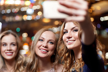 Image showing women with smartphone taking selfie at night club