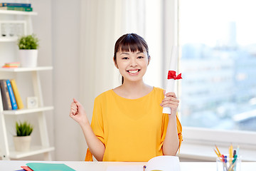 Image showing happy asian woman student with diploma at home