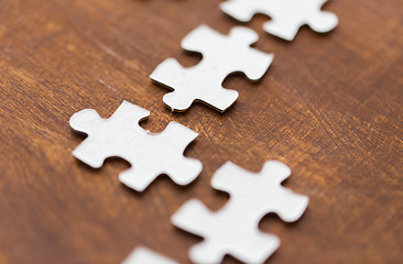 Image showing close up of puzzle pieces on wooden surface