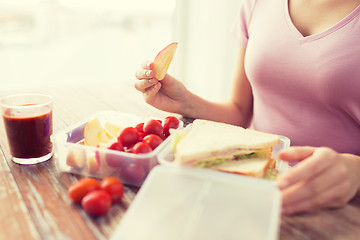 Image showing close up of woman with food in plastic container