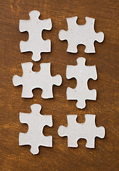 Image showing close up of puzzle pieces on wooden surface