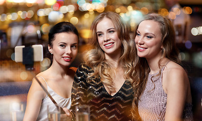 Image showing women with smartphone taking selfie at night club