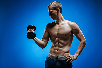 Image showing Fit young man with beautiful torso on blue background