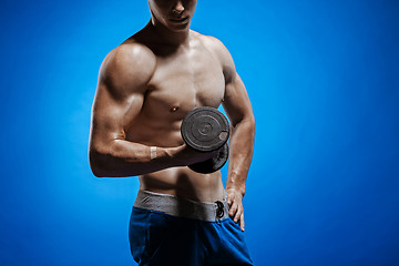 Image showing Fit young man with beautiful torso on blue background