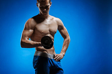 Image showing Fit young man with beautiful torso on blue background