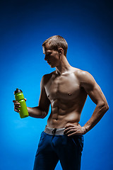 Image showing Fit young man with beautiful torso on blue background