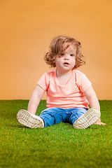 Image showing One cute baby girl on orange background