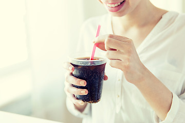 Image showing close up of happy woman drinking coca cola