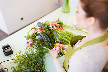 Image showing close up of woman making bunch at flower shop