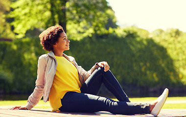 Image showing happy african american young woman in summer park