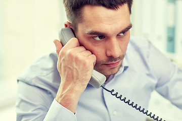 Image showing face of businessman calling on phone in office