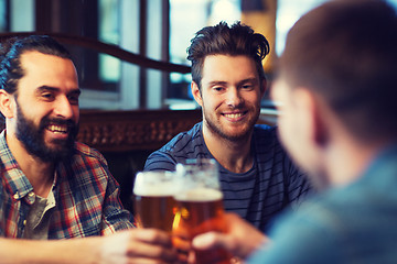 Image showing happy male friends drinking beer at bar or pub