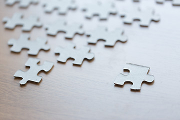 Image showing close up of puzzle pieces on wooden surface