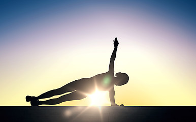 Image showing woman doing plank exercise on stairs over sunlight