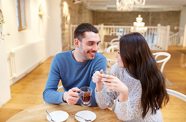 Image showing happy couple drinking tea at cafe