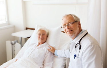 Image showing doctor visiting senior woman at hospital ward