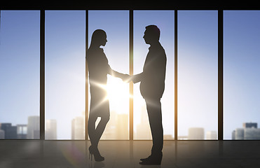 Image showing business partners silhouettes shaking hands