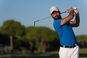 Image showing pro golfer hitting a sand bunker shot