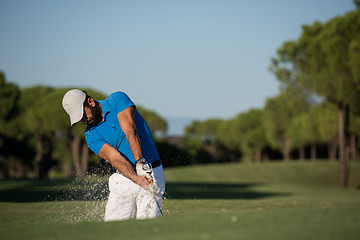 Image showing pro golfer hitting a sand bunker shot