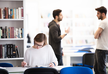 Image showing female student study in school library, group of students in bac