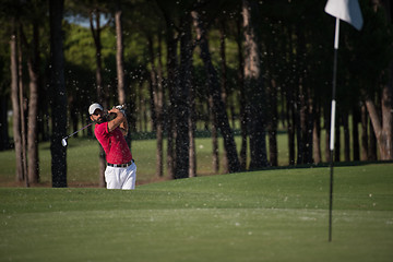 Image showing golfer hitting a sand bunker shot