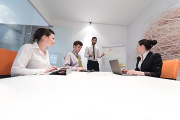 Image showing business people group brainstorming and taking notes to flip boa