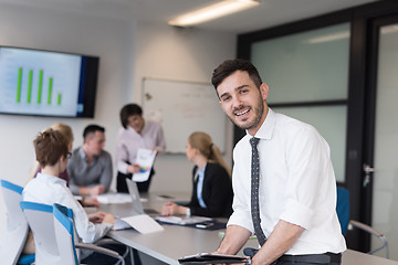 Image showing young business man with tablet at office meeting room