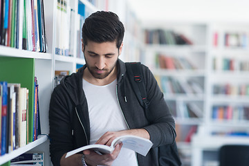 Image showing portrait of student while reading book  in school library