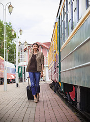 Image showing beautiful middle-aged woman with a luggage