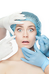 Image showing Plastic surgery concept. Doctor hands in gloves touching woman face