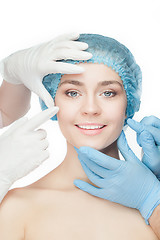 Image showing Plastic surgery concept. Doctor hands in gloves touching woman face