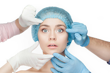 Image showing Plastic surgery concept. Doctor hands in gloves touching woman face