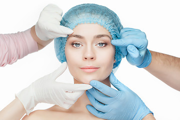 Image showing Plastic surgery concept. Doctor hands in gloves touching woman face