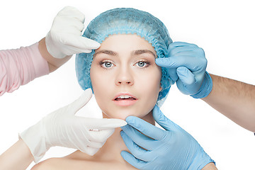 Image showing Plastic surgery concept. Doctor hands in gloves touching woman face